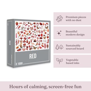 May include: A 1000-piece jigsaw puzzle with a grey border and the word "RED" in large white letters. The puzzle image features a collage of red objects, including a strawberry, birds, and a bicycle. The box also states "Premium pieces with no dust".