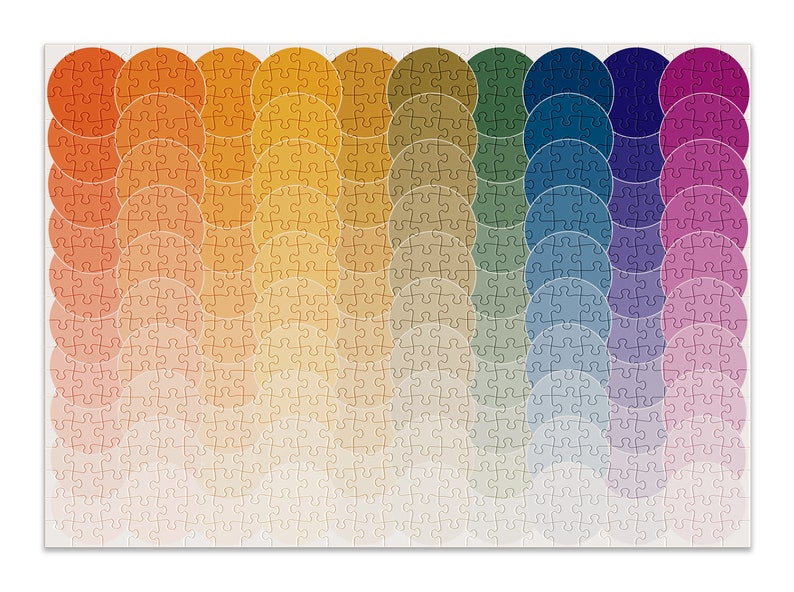 May include: A colorful jigsaw puzzle with a rainbow pattern of overlapping circles. The puzzle pieces are arranged in a wave-like pattern, with the colors transitioning from red to orange, yellow, green, blue, purple, and pink.
