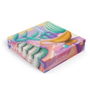 May include: A colorful box with a purple, pink, and yellow design. The box features a whimsical illustration of a genie lamp, a leafy plant, and a geometric shape. The text "VOTIVE" is printed on the box.