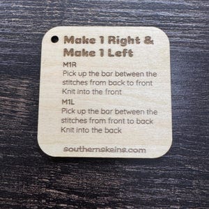 May include: A light-colored wooden knitting instruction card with rounded corners. The card has the text "Make 1 Right & Make 1 Left" and instructions for M1R and M1L. The website southernskeins.com is printed at the bottom.