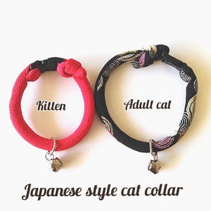 May include: Two Japanese-style cat collars, one red and one black with gold accents. The red collar is labelled "Kitten" and the black collar is labelled "Adult cat". Both collars have a silver bell attached.