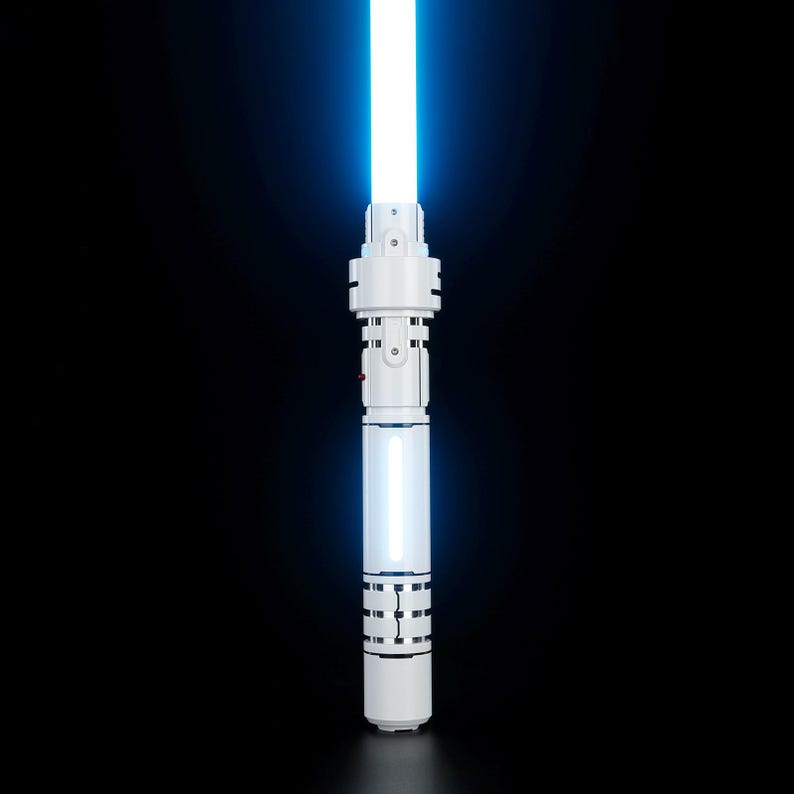 May include: A white lightsaber with a blue blade. The lightsaber has a black handle with a silver band and a silver button.