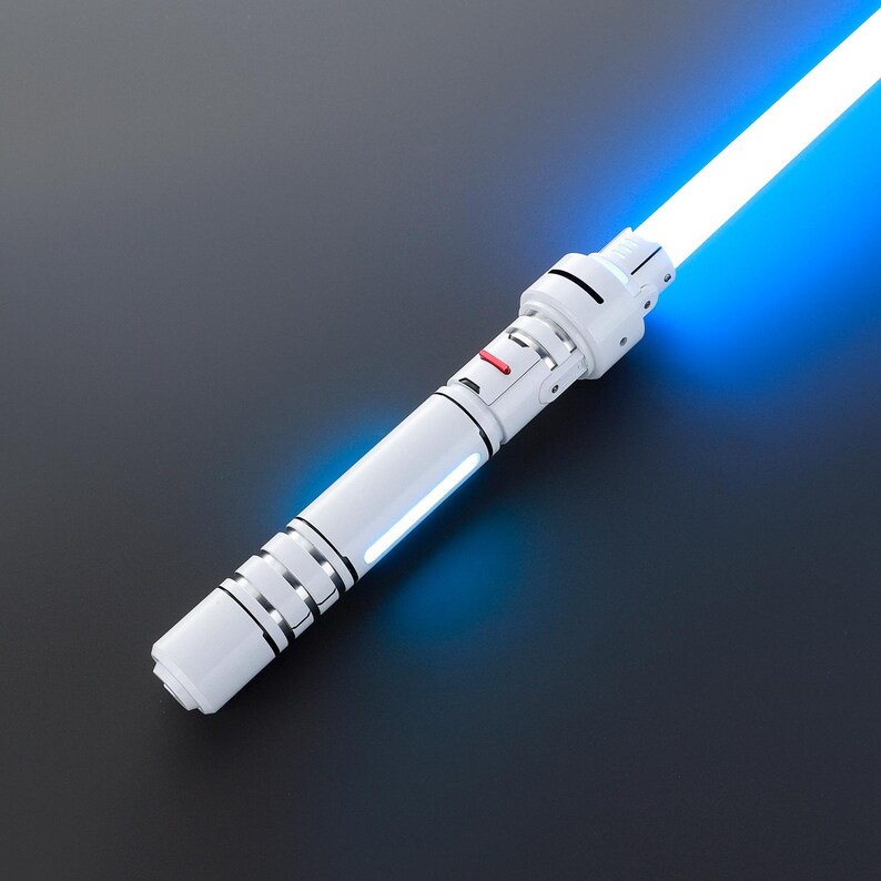 May include: A white lightsaber with a blue blade. The lightsaber has a silver accent and a red button.