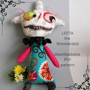 May include: A handmade monster doll named "LOTTA" with a white head featuring embroidered details like a stitched mouth and eye. The doll wears a turquoise dress with floral patterns and pink sleeves. The image also includes the text "downloadable PDF pattern".