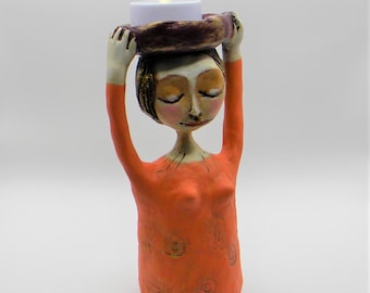 Clay sculpture of female goddess light bearer