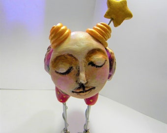 Whimsical clay bird sculpture