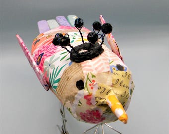 Whimsical paper collage bird 3D sculpture with wire legs and wire crown