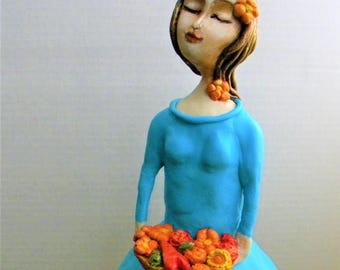 Santos cage doll clay sculpture on a recycled candle holder base