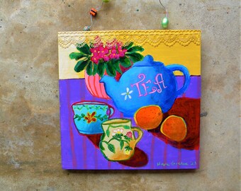 Colorful whimsical still life with teapot and oranges