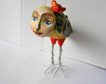 Whimsical clay bird sculpture