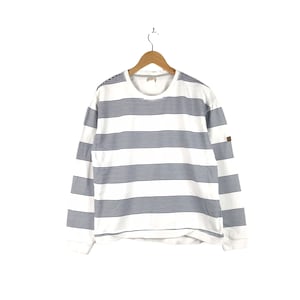 May include: White long-sleeve shirt with blue horizontal stripes.