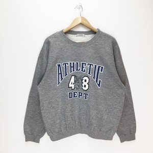 May include: Grey sweatshirt with a blue and white graphic print that says "Athletic 48 Dept."