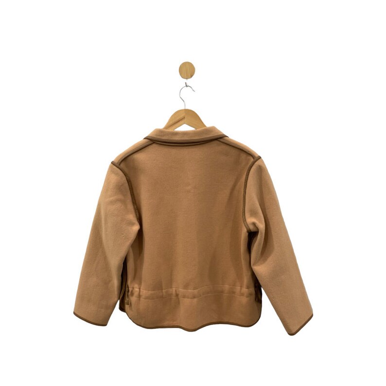 May include: A brown fleece jacket with a brown trim around the collar, pockets, and hem.