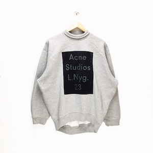 May include: A gray sweatshirt with a black square print that says "Acne Studios L.Nyg. 23"