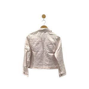 May include: A light pink denim jacket with long sleeves and a button closure.