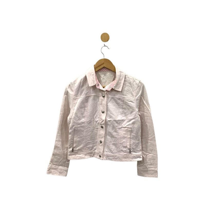May include: A light pink denim jacket with a button closure and long sleeves. The jacket has a white and pink checked lining visible at the collar.