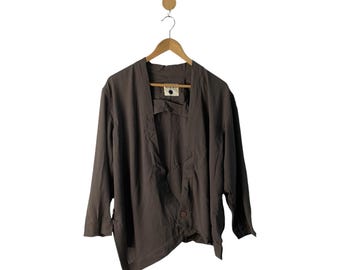 May include: A brown, lightweight, long-sleeved jacket with a single button closure. The jacket has a relaxed fit and a slightly asymmetrical hem.