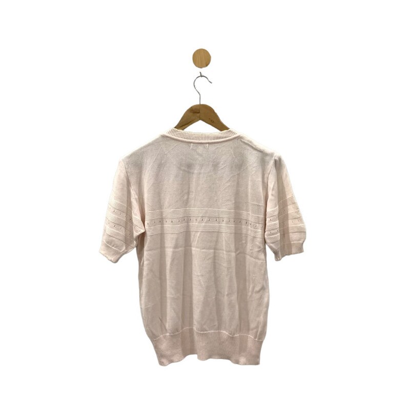 May include: A pale pink short-sleeved knitted sweater with a delicate pattern around the neckline and a horizontal band of the same pattern across the chest.