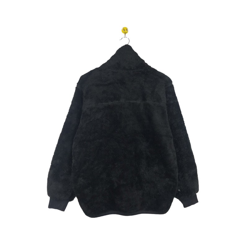 May include: A black fleece jacket with a zipper closure. The jacket has a soft, fuzzy texture.