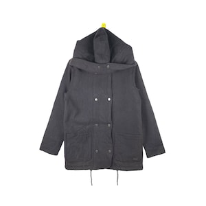 May include: A dark grey hooded jacket with a double-breasted closure and two front pockets. The jacket has a drawstring at the bottom.