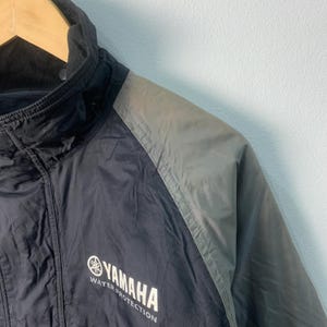 May include: Black and gray jacket with a zipper closure and a Yamaha logo that says "Water Protection".