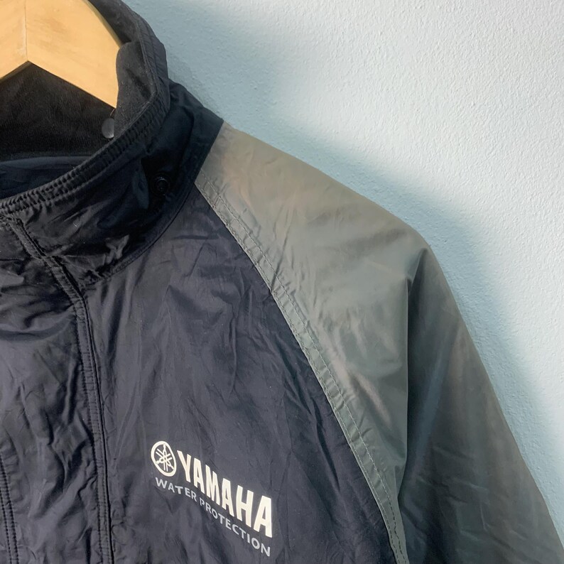 May include: Black and gray jacket with a zipper closure and a Yamaha logo that says "Water Protection".