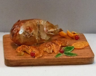 Dollhouse miniature accessory/furniture in twelfth scale or 1:12 scale.  Carved turkey on a cutting board. Item #D687.