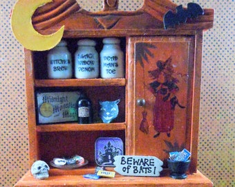 Dollhouse miniature furniture in twelfth scale or 1:12 scale. Orange Halloween hutch wit decorations. Item #N691.