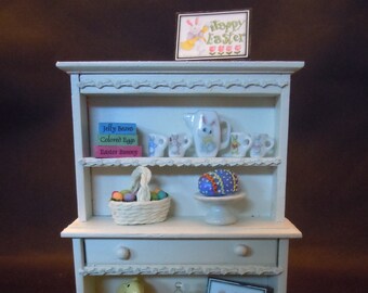 Dollhouse miniature furniture in twelfth scale or 1:12 scale.   Off white hutch decorated for Easter.    Item #N543.