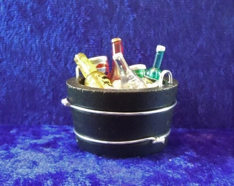 Dollhouse miniature accessory/drinks in twelfth scale or 1:12 scale.  Black bucket with ice and assortment of drinks.   Item #C277.