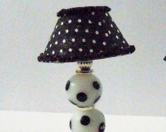 Dollhouse miniature accessory in twelfth scale or 1:12 scale. Single white lamp with black polka dots.    Item #N679.