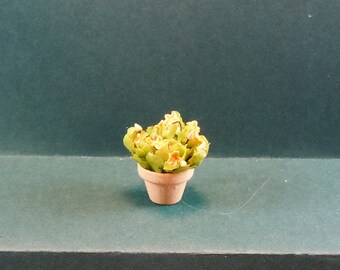 Dollhouse miniature accessory/furniture in twelfth scale or 1:12 scale.  Small flower arrangement in terra cotta pot. Item #D606.