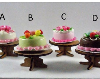 Dollhouse miniature accessory in twelfth scale or 1:12 scale. Wooden cake stand with cake.  Item #N744.