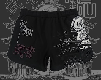 May include: Black athletic shorts with a white and gray Japanese-inspired print. The shorts have a drawstring waistband and the words "FLOW" and "道着" are printed on the front.