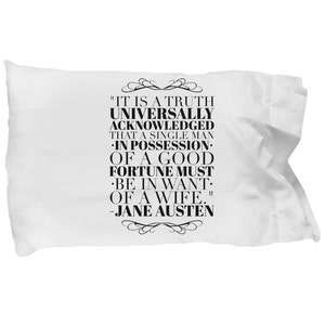 May include: A white pillow with black text that reads "IT IS A TRUTH UNIVERSALLY ACKNOWLEDGED THAT A SINGLE MAN IN POSSESSION. OF A GOOD FORTUNE MUST BE IN WANT. OF A WIFE." -JANE AUSTEN