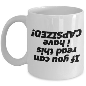 May include: White ceramic coffee mug with black text that reads "If you can read this, I have capsized!"