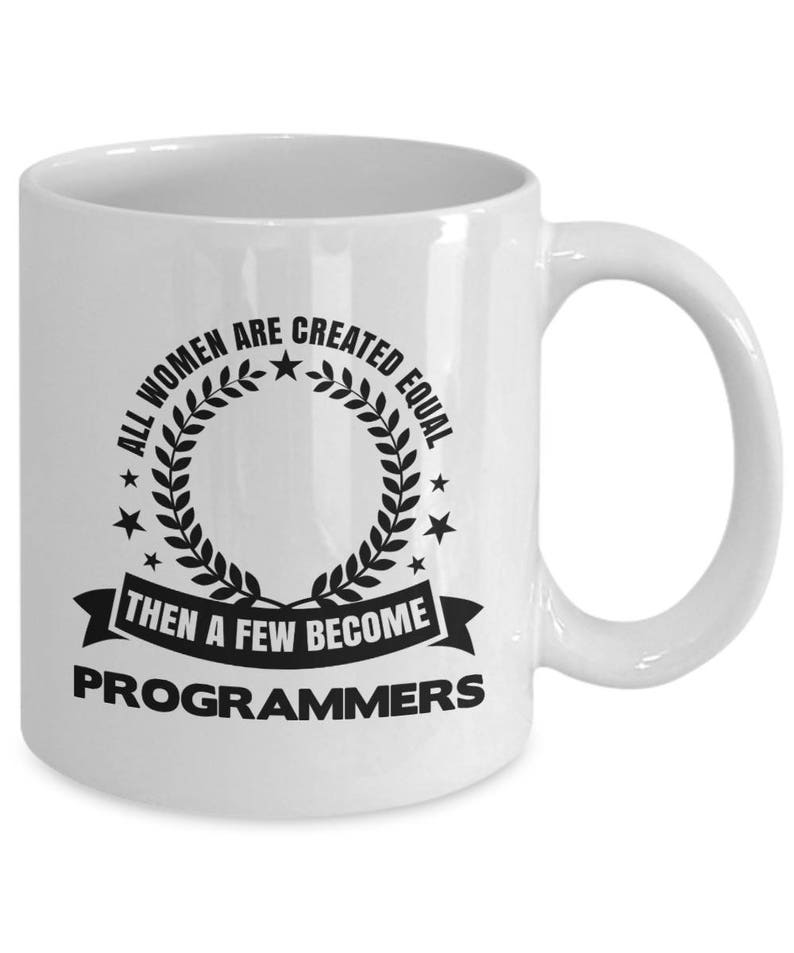 May include: White ceramic coffee mug with a black graphic that reads "All women are created equal then a few become programmers".
