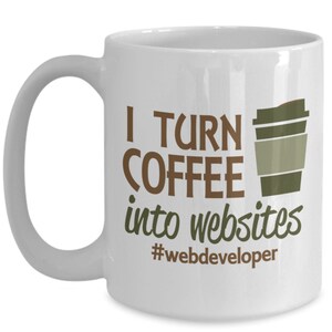 May include: White ceramic coffee mug with brown text that reads "I turn coffee into websites #webdeveloper". A brown and green cartoon coffee cup is to the right of the text.