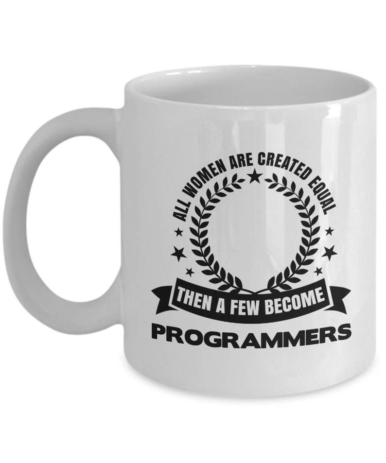 May include: White ceramic coffee mug with a black graphic that reads "All women are created equal then a few become programmers".