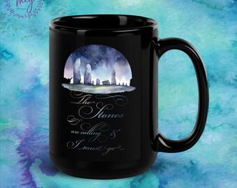 May include: Black coffee mug with a watercolor illustration of a stone circle under a starry sky. The text reads "The Stones are calling & I must go..."