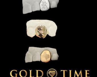 May include: Three gold tooth grills with different designs. The first grill has a letter "R" engraved on it. The second grill has a scorpion design. The third grill has the state of Texas engraved on it. The image is from Gold Time Fine Jewelry & Watches.
