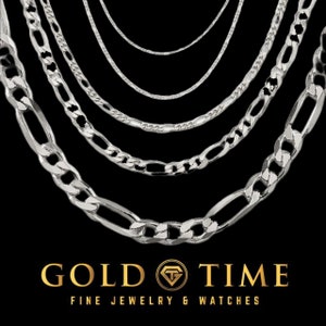 May include: A set of six silver chains of varying widths and styles, hanging against a black background. The chains are all made of a shiny metal and have a classic look. The image includes the text "GOLD TIME FINE JEWELRY & WATCHES".
