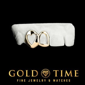May include: Gold grill with two heart-shaped cutouts. The grill is set on a white mould.