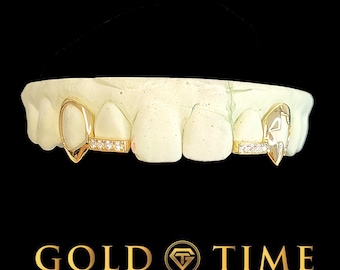 May include: Gold tooth grill with diamond accents. The grill is shaped like a teardrop with a small diamond bar in the center. The grill is set on a white mold of a mouth.