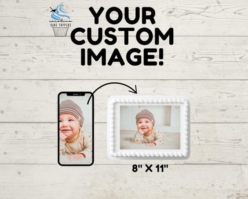 May include: White cake topper with a white frame and a photo of a baby wearing a brown and white hat. The cake topper is 8 inches by 11 inches. "Your Custom Image!" is written in black text above the cake topper.