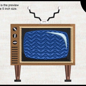 Peut inclure: Un téléviseur de style vintage avec un cadre en bois brun et un écran bleu avec un motif en zigzag. Le téléviseur a une paire d'antennes sur le dessus et repose sur deux pieds.