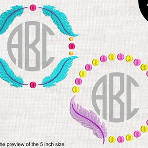 May include: Two embroidery designs featuring a circle with the letters ABC inside. The top design has turquoise feathers and pink and yellow dots. The bottom design has a pink feather and a circle of pink and yellow dots.