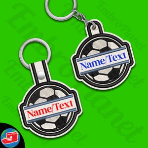 May include: Black and white football keychain with a grey and blue banner that says "Name/Text".