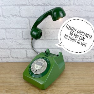 May include: Green rotary phone with a flexible goose neck lamp attached to the handset. The lamp is turned on and the phone has a white dial with the text "Call me Old Fashioned".