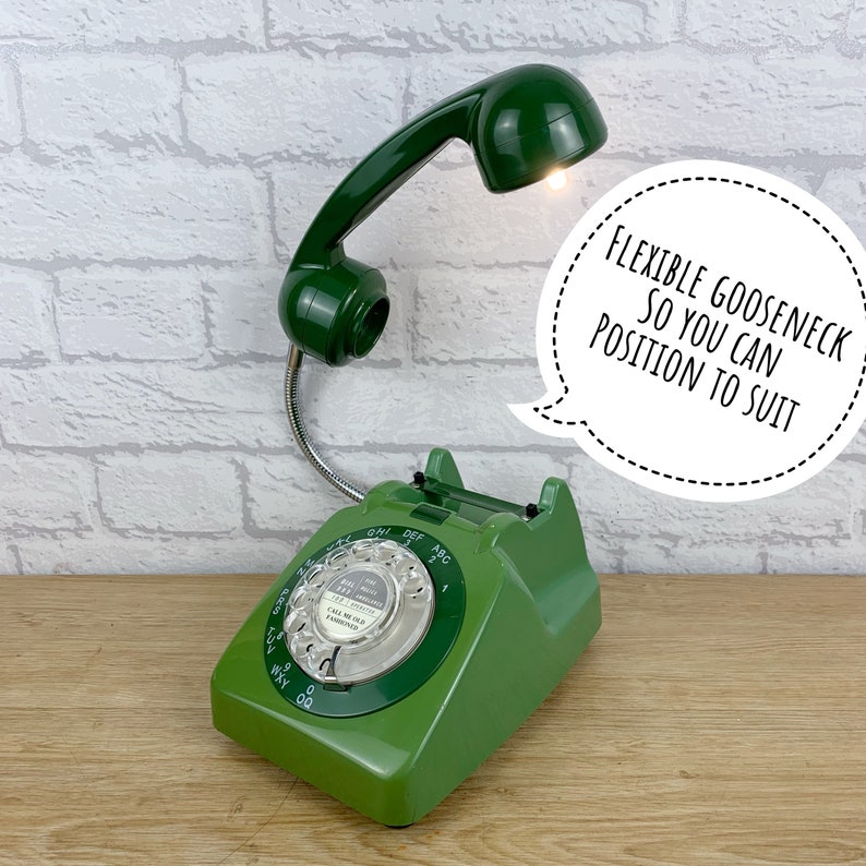 May include: Green rotary phone with a flexible goose neck lamp attached to the handset. The lamp is turned on and the phone has a white dial with the text "Call me Old Fashioned".